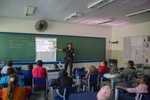 guarda civil de cotia dando palestra a crianças em sala de aula