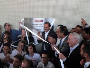 presidente da Fiesp, Ciesp, Sesi-SP e SENAI-SP Paulo Skaf, vice-prefeito de Cotia Almir Rodrigues removem a faixa inaugural da placa do Senai enquanto alunos do SENAI posam para foto