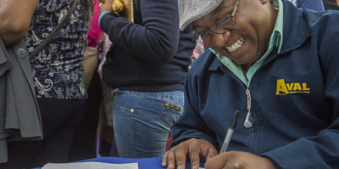 homem sorridente preenchendo formulário